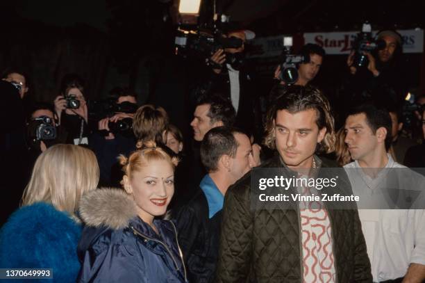 American singer Gwen Stefani, wearing a blue Tommy Hilfiger parka, and British singer, songwriter and guitarist Gavin Rossdale, wearing a green...