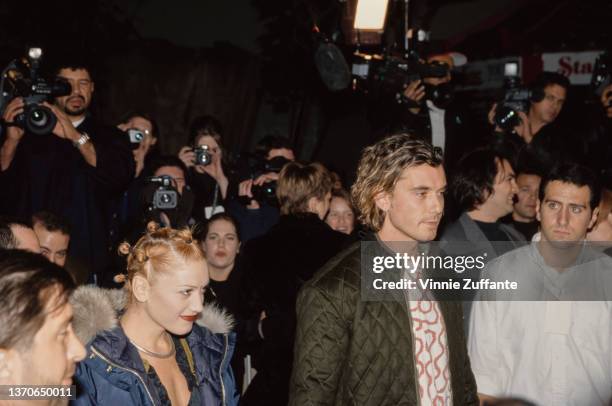 American singer Gwen Stefani, wearing a blue Tommy Hilfiger parka, and British singer, songwriter and guitarist Gavin Rossdale, wearing a green...