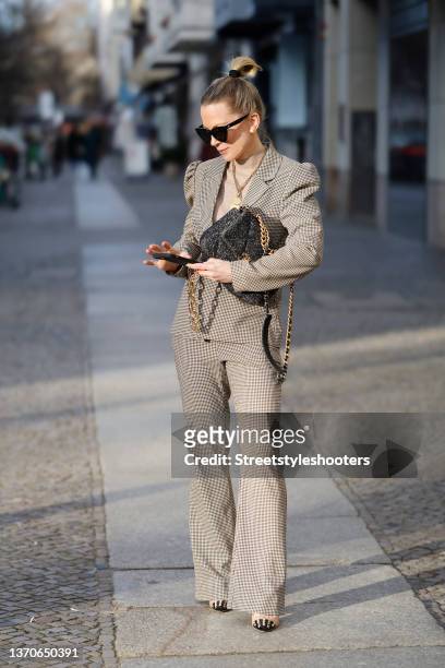 German TV host Tamara von Nayhauss wearing a beige turtleneck pullover by Mos Mosh, a black and beige suit with houndstooth pattern by Pieces, gold...