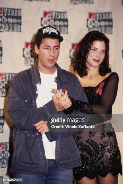 American comedian and actor Adam Sandler and American actress Sandra Bullock in the press room of the 1994 MTV Video Music Awards, held at Radio City...