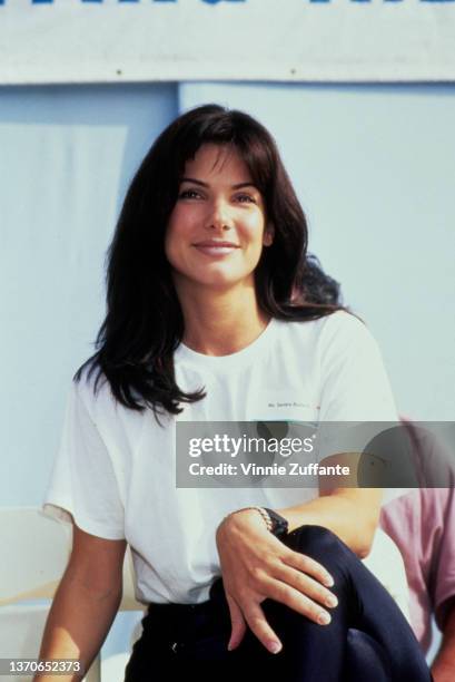 American actress Sandra Bullock, wearing a white t-shirt with a nametag, attends the AIDS Walk, a walkathon organised by AIDS Project Los Angeles ,...