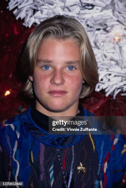 America child actor Zachery Ty Bryan, wearing a blue sweater with multi-coloured detail, circa 1995.