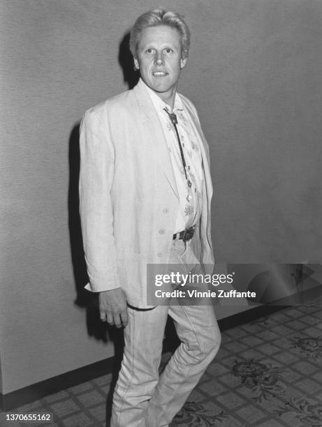 American actor Gary Busey sporting a slimline physique and blonde hair at an hotel in Los Angeles, California, circa 1987.