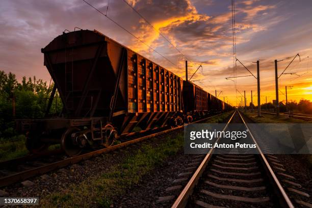freight train on the railroad at sunset. rail freight and passenger transportation - long journey stock pictures, royalty-free photos & images