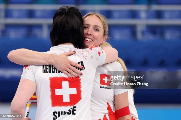 Melanie Barbezat and Esther Neuenschwander of Team Switzerland celebrate their victory against Team United States during the Women’s Curling Round...