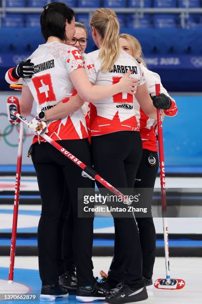 Esther Neuenschwander, Alina Paetz, Melanie Barbezat and Silvana Tirinzoni of Team Switzerland celebrate their victory against Team United States...