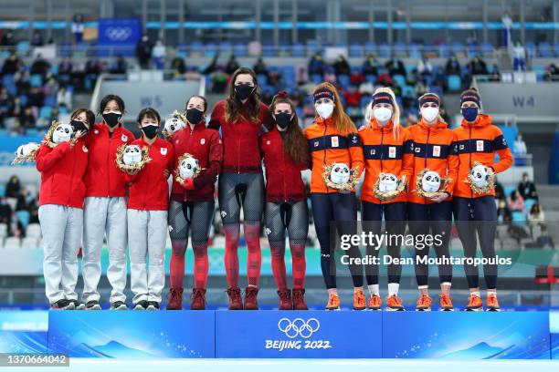 Gold medallists Team Canada , Silver Medallists Team Japan and Bronze Medallists Team Netherlands pose during the Women's Team Pursuit Final flower...