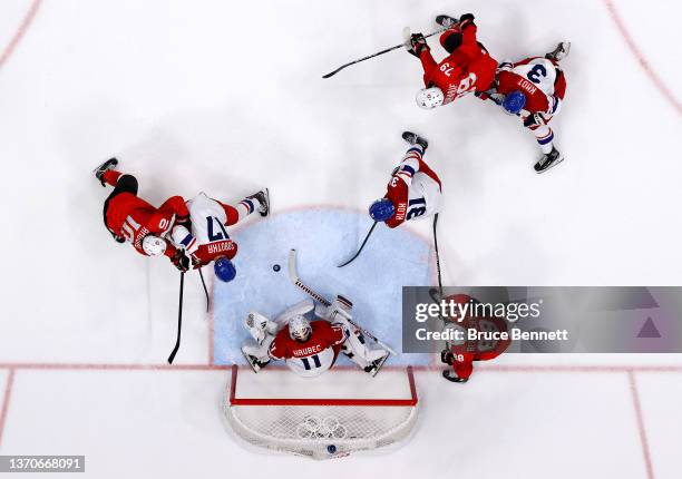 Andres Ambuhl of Team Switzerland, Vladimir Sobotka of Team Czech Republic and Simon Hrubec of Team Czech Republic challenge for the puck near the...