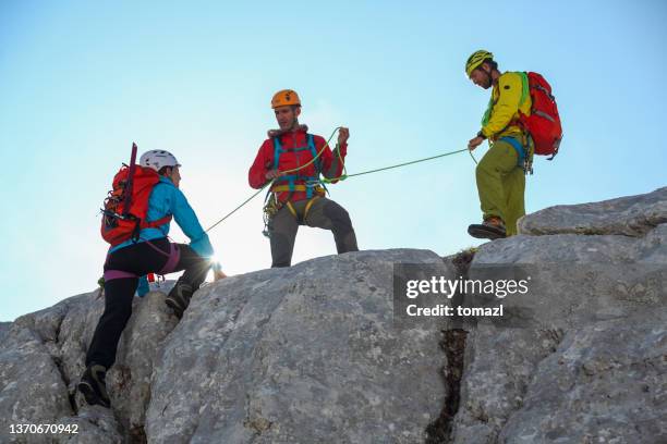 group of mountain climbers on their way to the top - belaying stock pictures, royalty-free photos & images