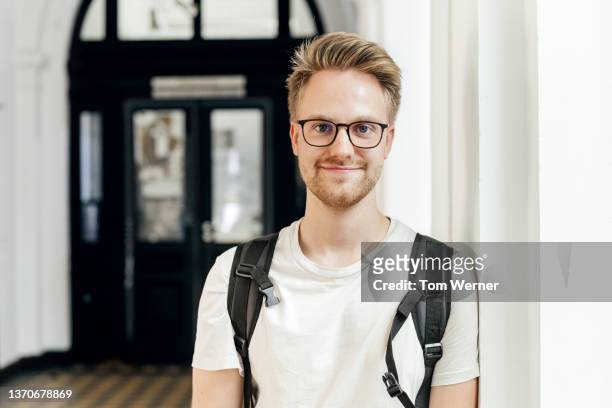 portrait of college student wearing glasses - student stock-fotos und bilder