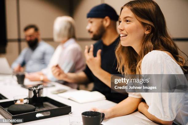 smiling woman at business meeting - boardmember stock pictures, royalty-free photos & images