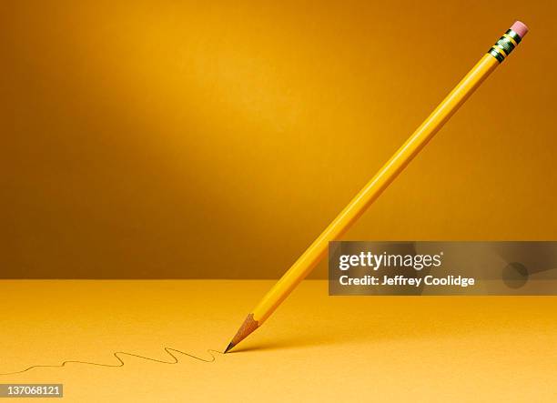 suspended pencil with squiggle - yellow pencil stock pictures, royalty-free photos & images