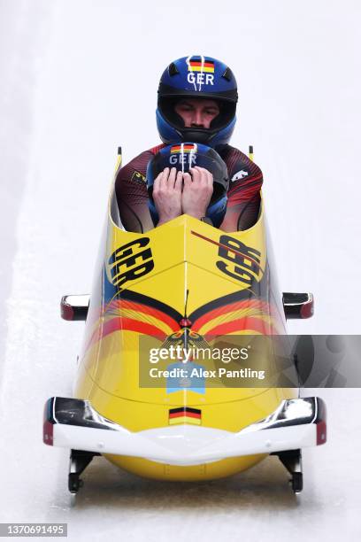 Christoph Hafer and Matthias Sommer of Team Germany react during the 2-man Bobsleigh Heat 3 on day 11 of Beijing 2022 Winter Olympic Games at...