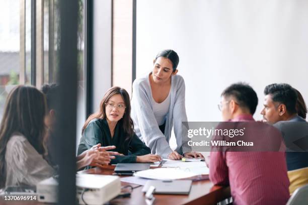 mature woman leads meeting - bly bildbanksfoton och bilder