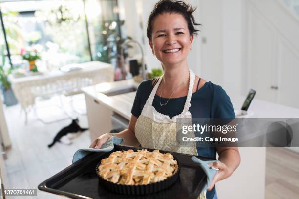 portrait proud woman with baked lattice pie in kitchen - apple pie stock pictures, royalty-free photos & images