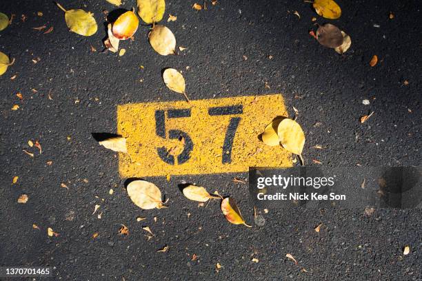 high angle view of a black and yellow stencil car park graphic - stencil foto e immagini stock