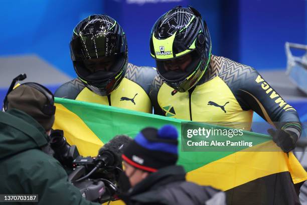 Shanwayne Stephens and Nimroy Turgott of Team Jamaica react during the 2-man Bobsleigh Heat 3 on day 11 of Beijing 2022 Winter Olympic Games at...