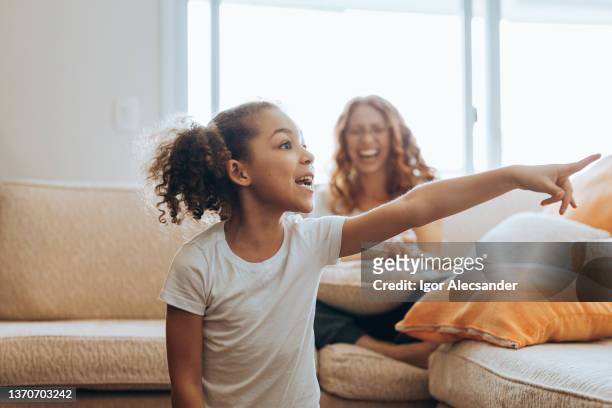 girl playing guessing things at home - pantomime stock pictures, royalty-free photos & images