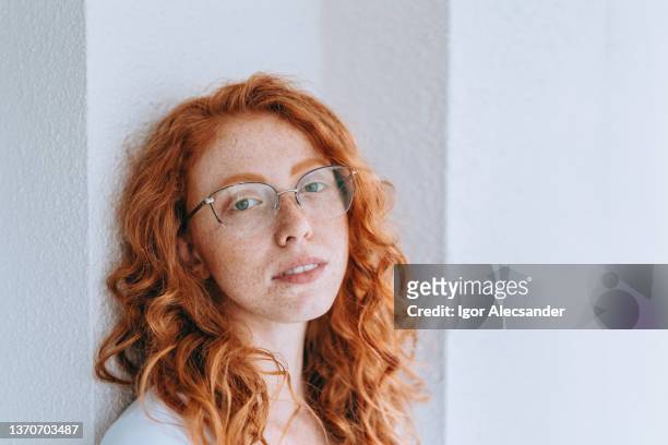 portrait of a red-haired woman - curly red hair glasses stock pictures, royalty-free photos & images