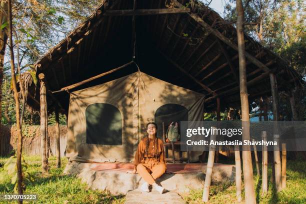 female traveler contemplating african sunrise from the camping site - tarangire national park stockfoto's en -beelden