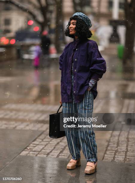 Sophia Roe is seen wearing a purple jacket and blue striped one piece outside the Ulla Johnson show during New York Fashion Week A/W 2022 on February...