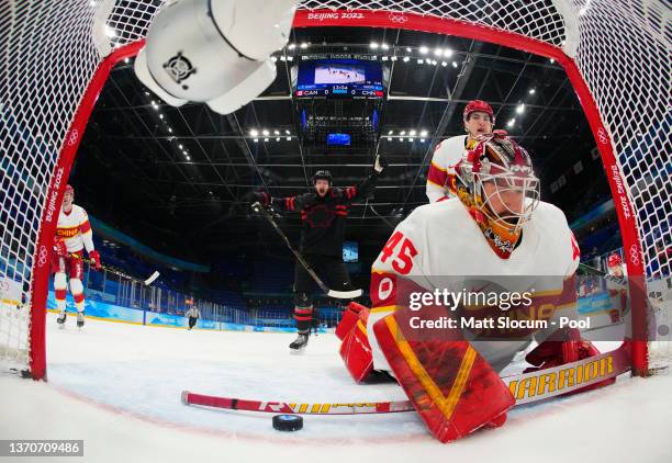 Eric Staal of Team Canada reacts as Shimisi Jieruimi of Team China watches the puck go into the goal from a shot by Jordan Weal of Team Canada in the...