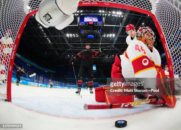 Eric Staal of Team Canada reacts as Shimisi Jieruimi of Team China watches the puck go into the goal from a shot by Jordan Weal of Team Canada in the...