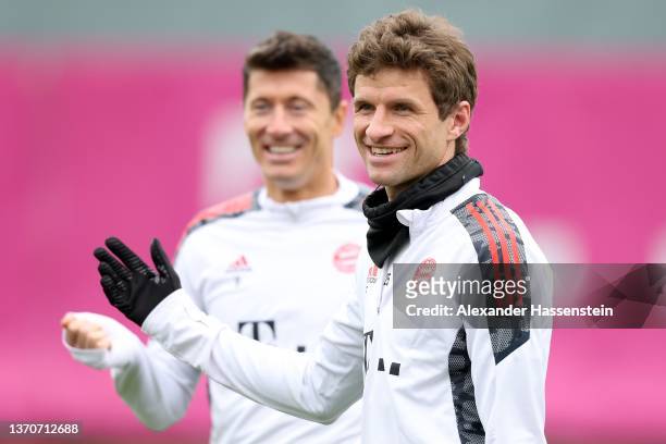 Thomas Müller of FC Bayern München smiles with team mate Robert Lewandowski during a training session at Saebener Strasse training ground on February...