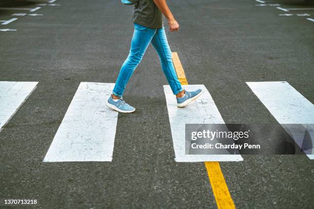 cropped shot of an unrecognisable man walking through the city in the morning - pedestrian crossing stock pictures, royalty-free photos & images