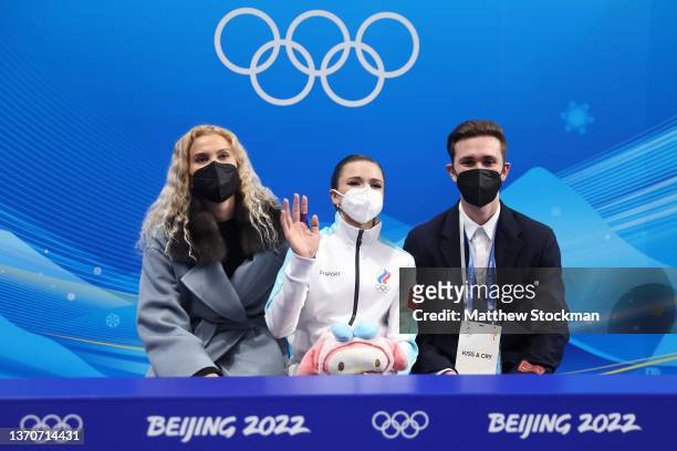 Kamila Valieva of Team ROC waits for their score with choreographer Daniil Gleikhengauz and coach Eteri Tutberidze during the Women Single Skating...