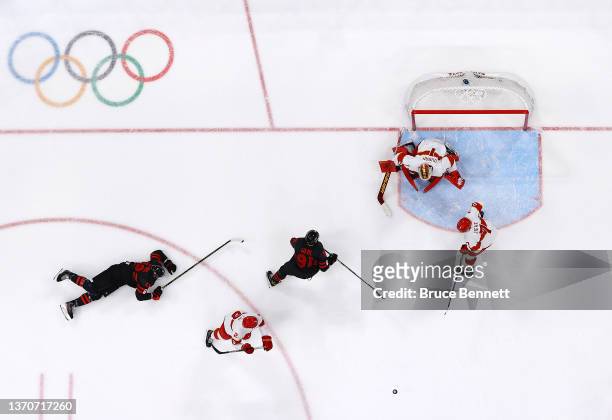 Yongli Ouban of Team China makes a save from a shot by Jordan Weal of Team Canada in the second period during the Men’s Ice Hockey Qualification...