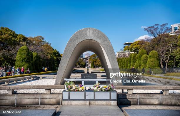 hiroshima victims memorial cenotaph - hiroshima bombing stock pictures, royalty-free photos & images