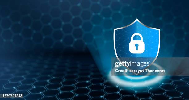 shield with key inside on blue background the concept of cybersecurity the internet - protegerse con las manos fotografías e imágenes de stock