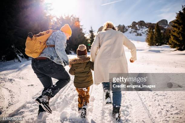 family in a winter walk - snow fun stock pictures, royalty-free photos & images
