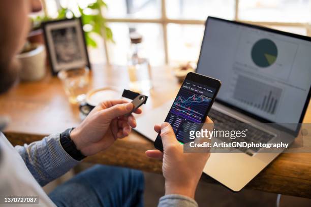 buying cryptocurrency and using digital wallet storage. - bitcoin phone stock pictures, royalty-free photos & images