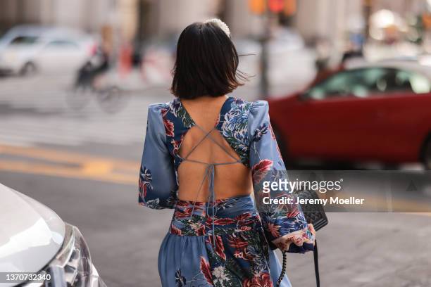Fashion Week Guest wearing a blue floral maxi dress and a black bag outside PatBo during New York City Fashion Week on February 12, 2022 in New York...