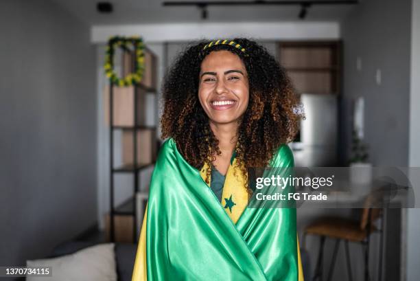 portrait of a happy sports fan wearing the green flag at home - ghanaian flag stock pictures, royalty-free photos & images