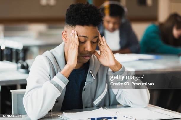 teen boy is stressed about test - stress test stockfoto's en -beelden