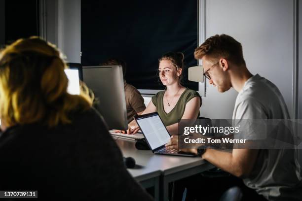 college students working at computers in dark seminar room - connected mindfulness work stock pictures, royalty-free photos & images