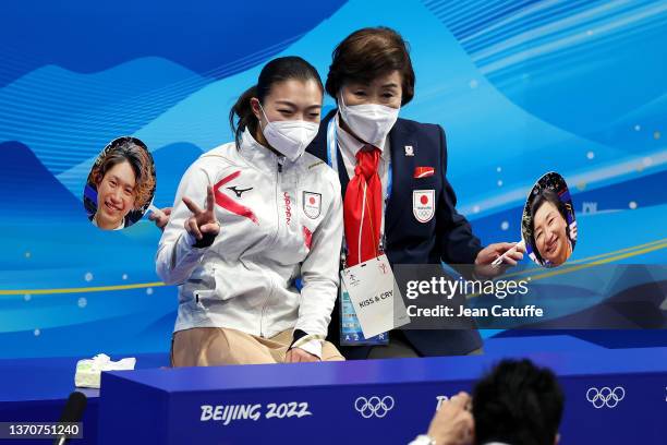 Kaori Sakamoto of Japan reacts with her coach at 'Kiss and Cry' during the Women Single Skating Short Program on day eleven of the Beijing 2022...