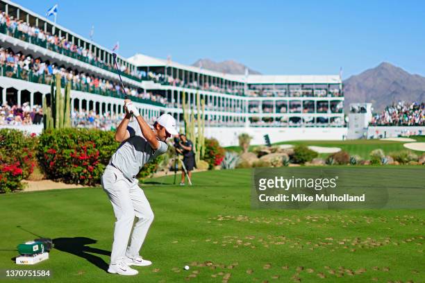 Scottie Scheffler of the United States hits his tee shot on the 16th hole during the final round of the WM Phoenix Open at TPC Scottsdale on February...