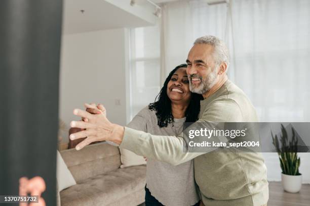 husband and wife dancing together in the living room - tango black stock pictures, royalty-free photos & images