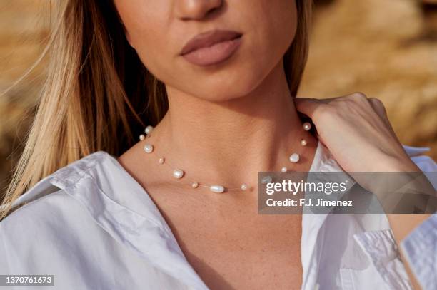 close-up of woman's lips and chest with necklace - female décolletage stock pictures, royalty-free photos & images