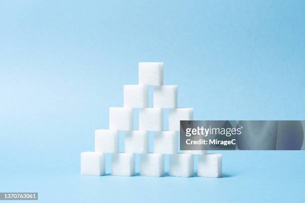 sugar cubes stack triangle shape - excess sugar stock pictures, royalty-free photos & images