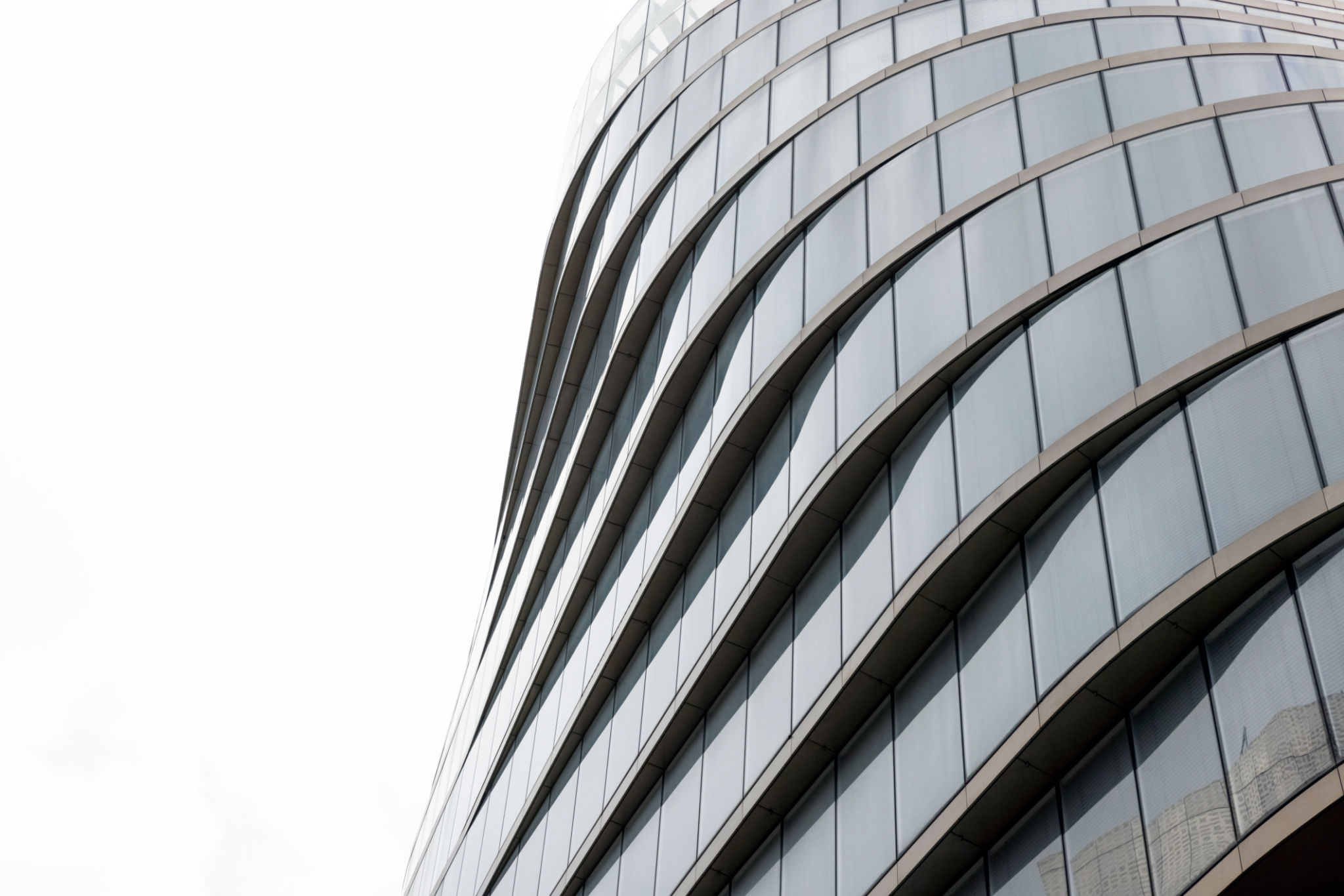 Closeup modern office building, white background with copy space Closeup modern office building, white background with copy space