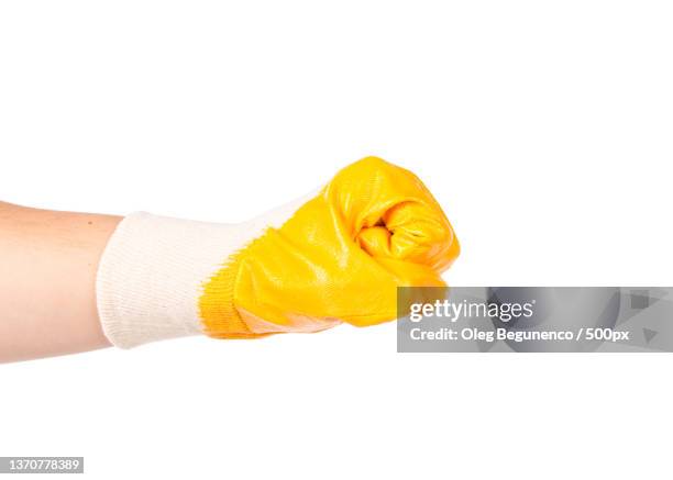 strong male worker hand glove clenching fist,moldova - yellow glove stock pictures, royalty-free photos & images