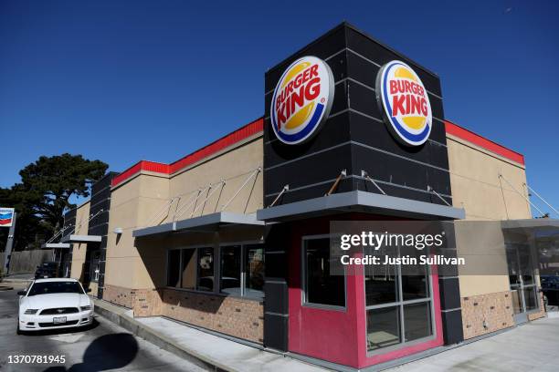 Car goes through the drive-thru at a Burger King restaurant on February 15, 2022 in Daly City, California. Restaurant Brands International, the...