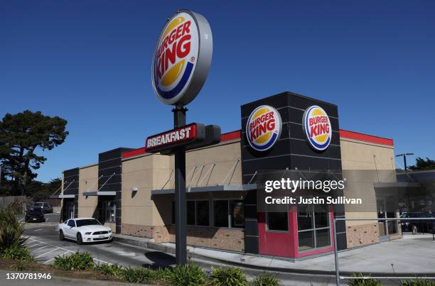 Car goes through the drive-thru a a Burger King restaurant on February 15, 2022 in Daly City, California. Restaurant Brands International, the parent...