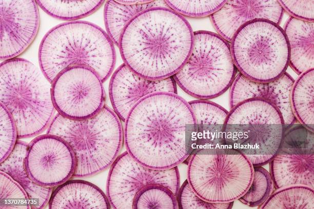 colorful slices of purple radish vegetable, close-up pattern of sliced radish - root vegetables stock pictures, royalty-free photos & images