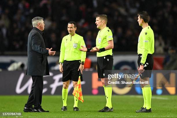 Carlo Ancelotti, Head Coach of Real Madrid speaks to Referee Daniele Orsato after their sides defeat during the UEFA Champions League Round Of...